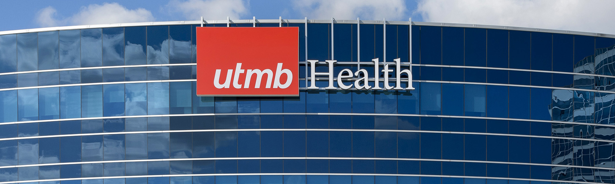 Building with UTMB Logo and clouded sky in background