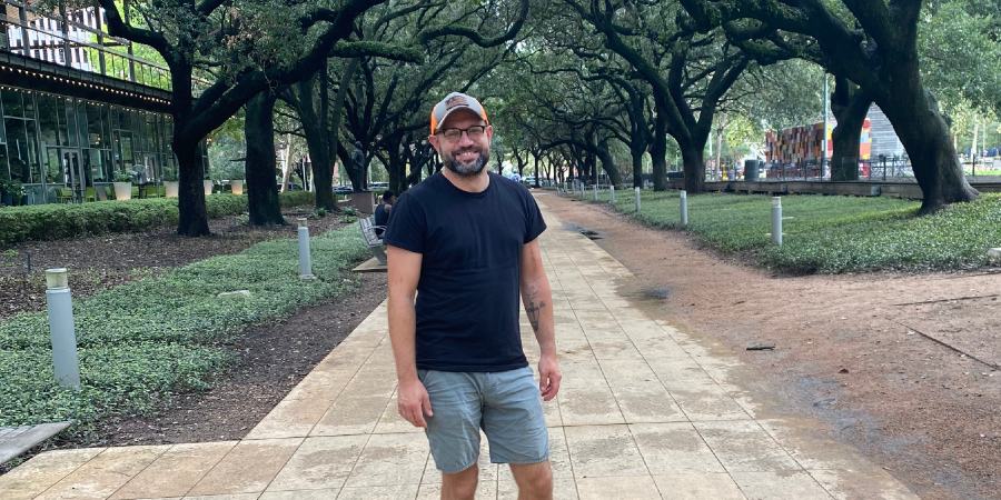 Image of man in shorts standing in a walkway