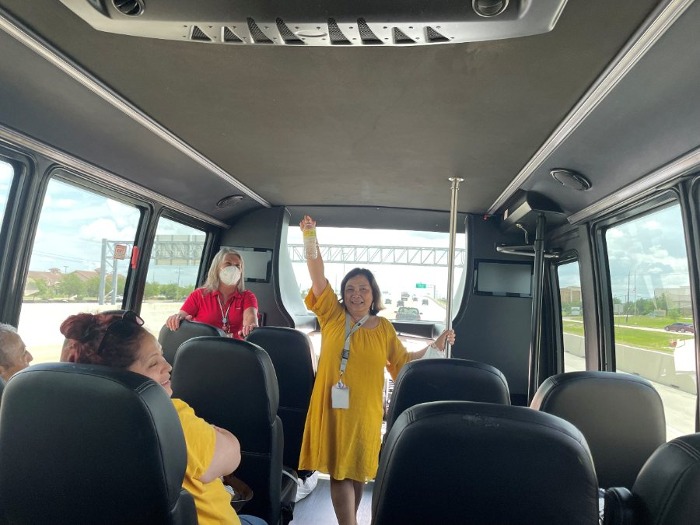 Woman on bus holding water bottle