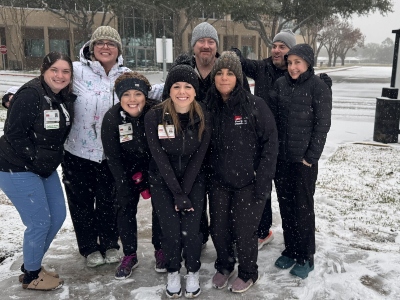 snow adc 1 Group of people smiling in the snow