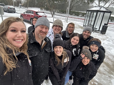 snow adc 3 Group of people smiling in the snow