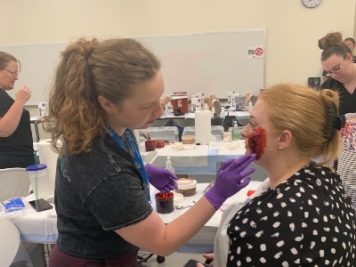 Photo of woman putting makeup on other woman
