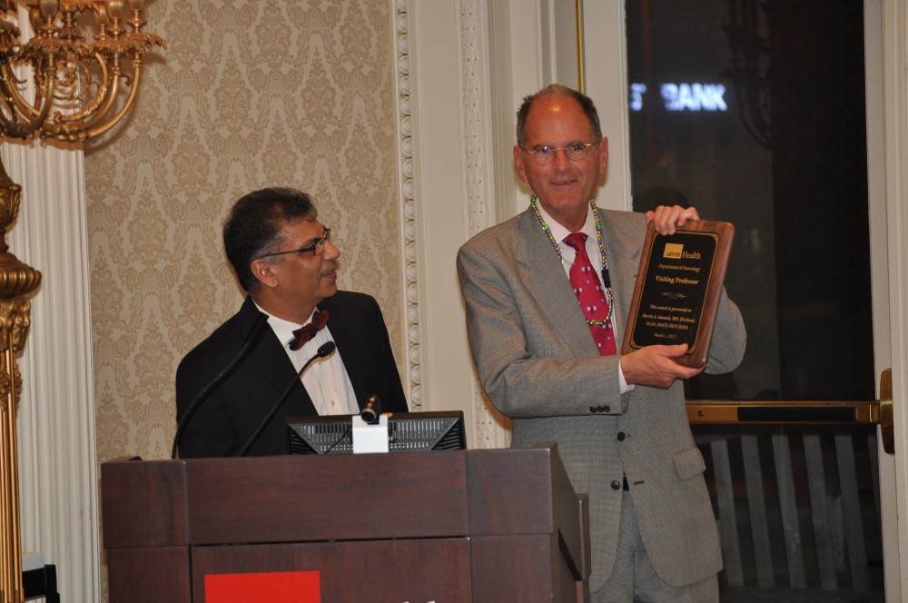 Photo of Drs. Bhardwaj presenting award to Dr. Martin Samuels