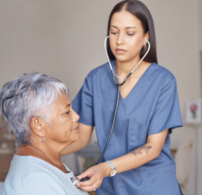 healthcare worker listening to an older adult woman's heart