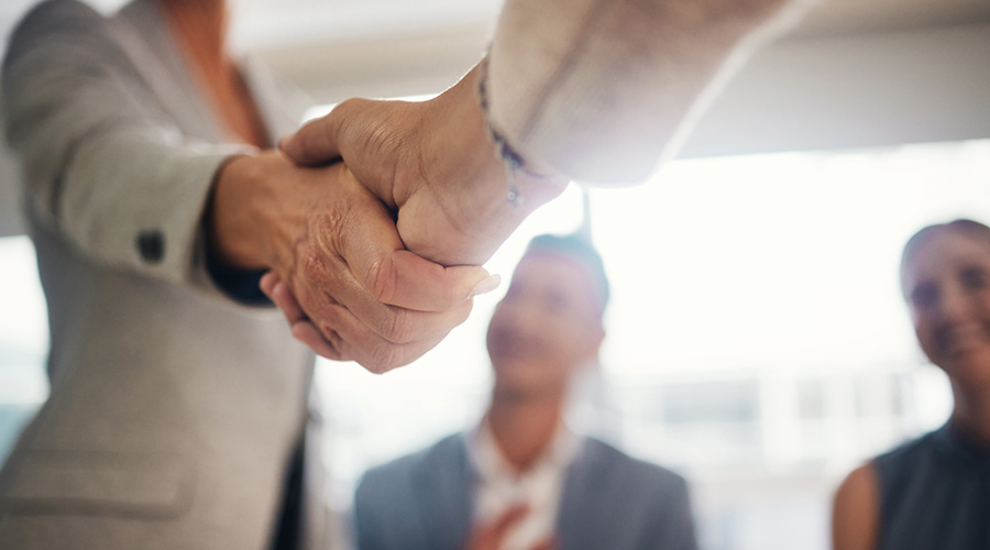 Close up of a person shaking hands with another person