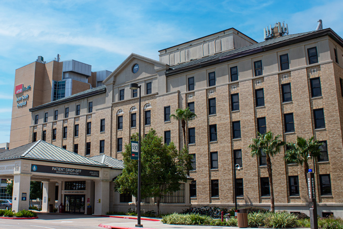 galveston-campus Exterior view of a UTMB Health building with a covered patient drop‑off entrance.