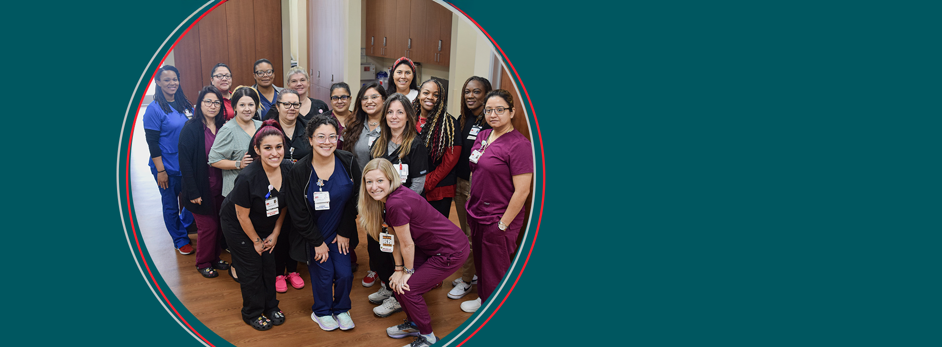 A large group of medical employees pose together smiling