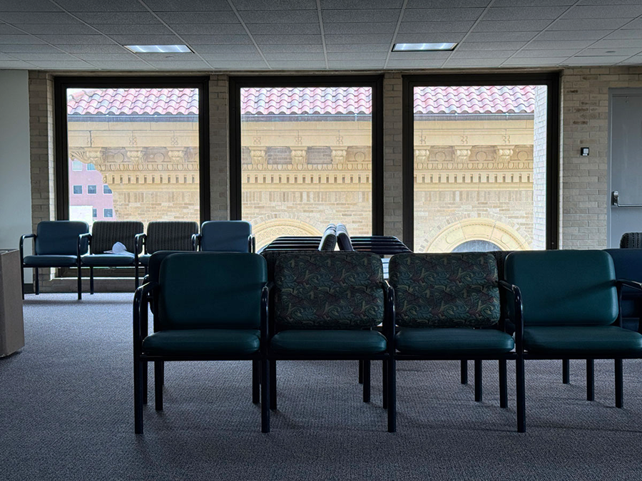 A photo of chairs and windows in a medical waiting room