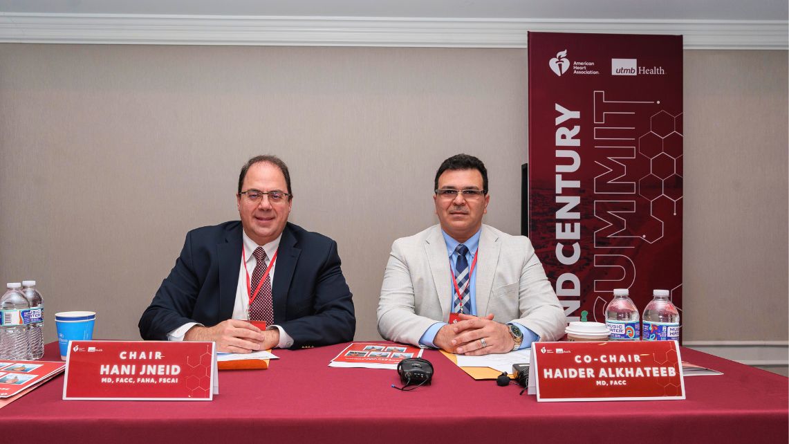 Dr. Hani Jneid and Dr. Haider Alkateeb sit at a table during the Second Century Summit